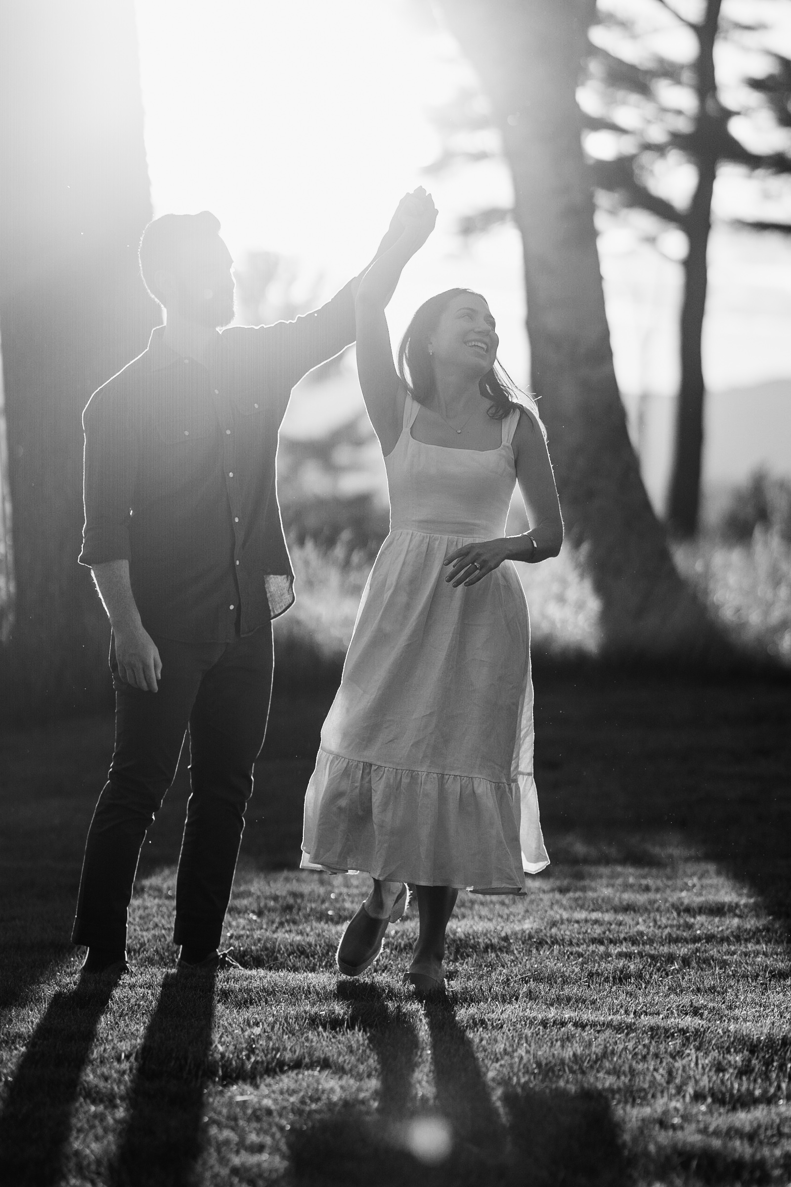 couple dancing in golden hour sunlit during vermont engagement session