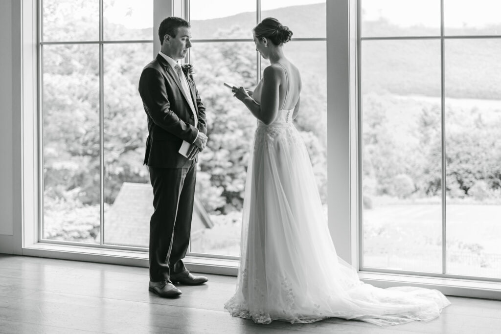 couple reading views in front of windows at mountain top resort in chittenden