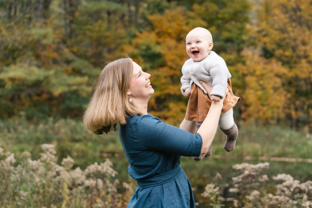 mother holding baby up in the air
