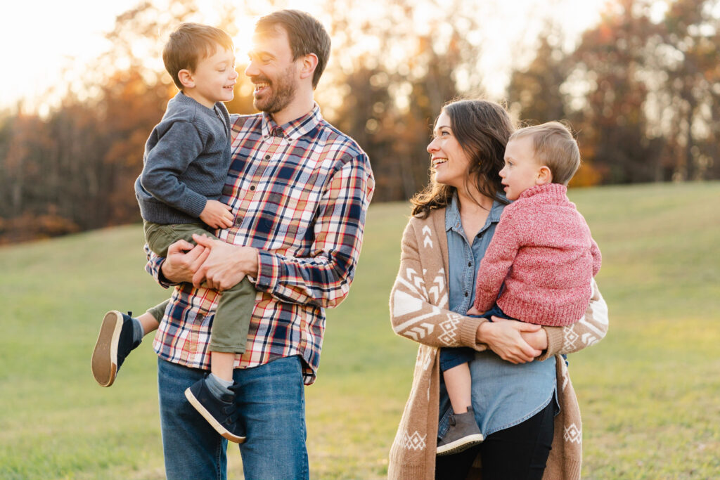 family standing with backlit sunshine during upper valley fall family photo session
