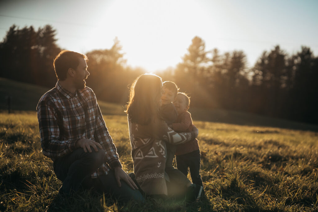 family holding each other at sunset during upper valley fall family photo session