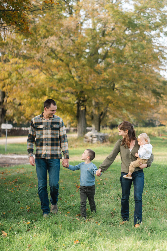 family walking holding hands, fall family photo session upper valley musterfield farm