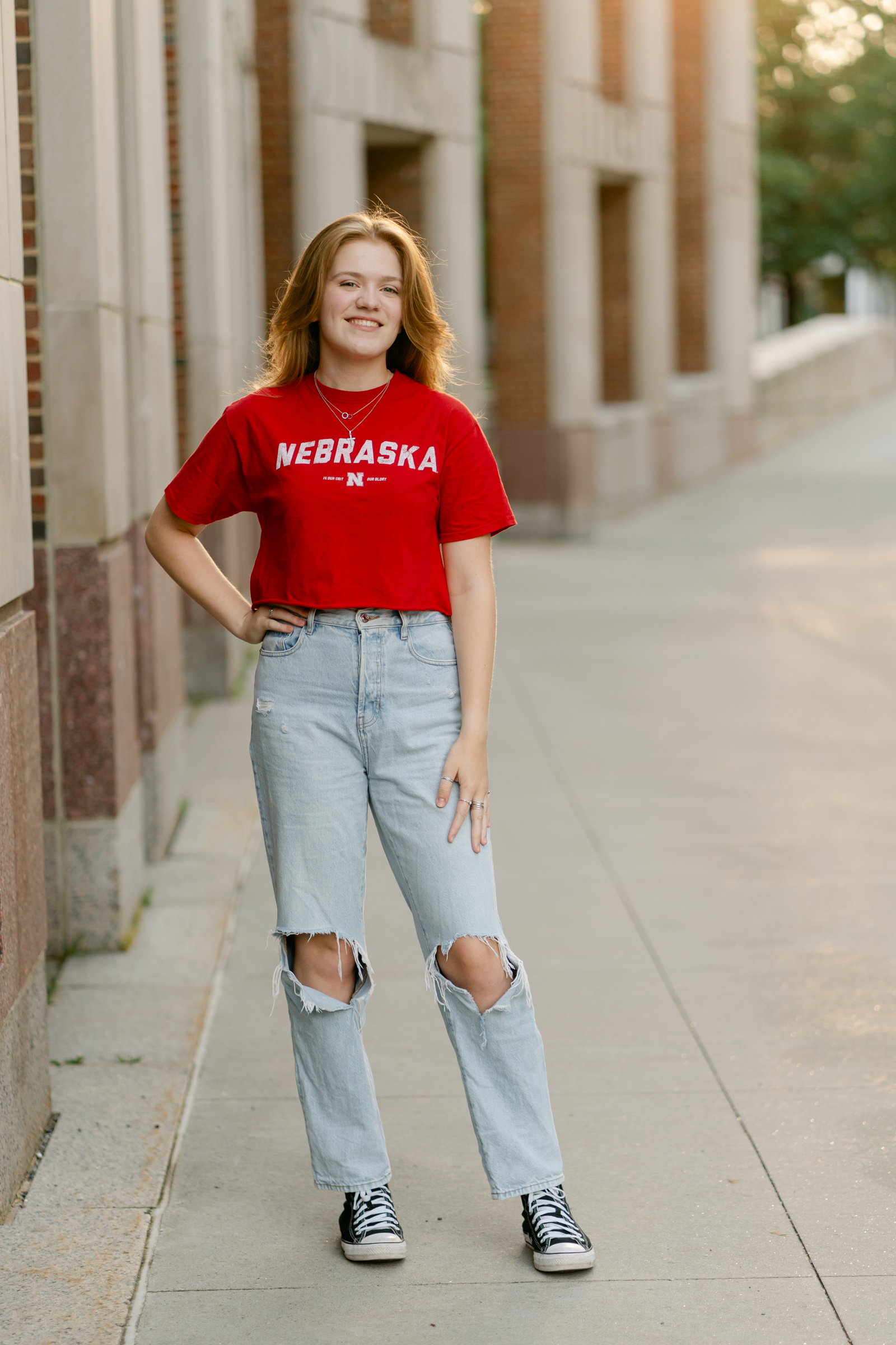 Upper Valley senior and graduate photo sessions lead image of girl standing with hands on hips during upper valley senior portrait session at dartmouth college in hanover nh