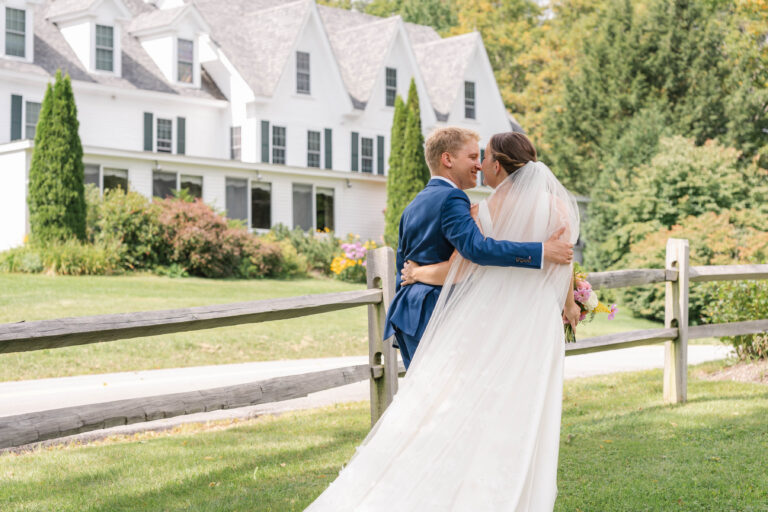 Married couple walking past Inn at Pleasant Lake