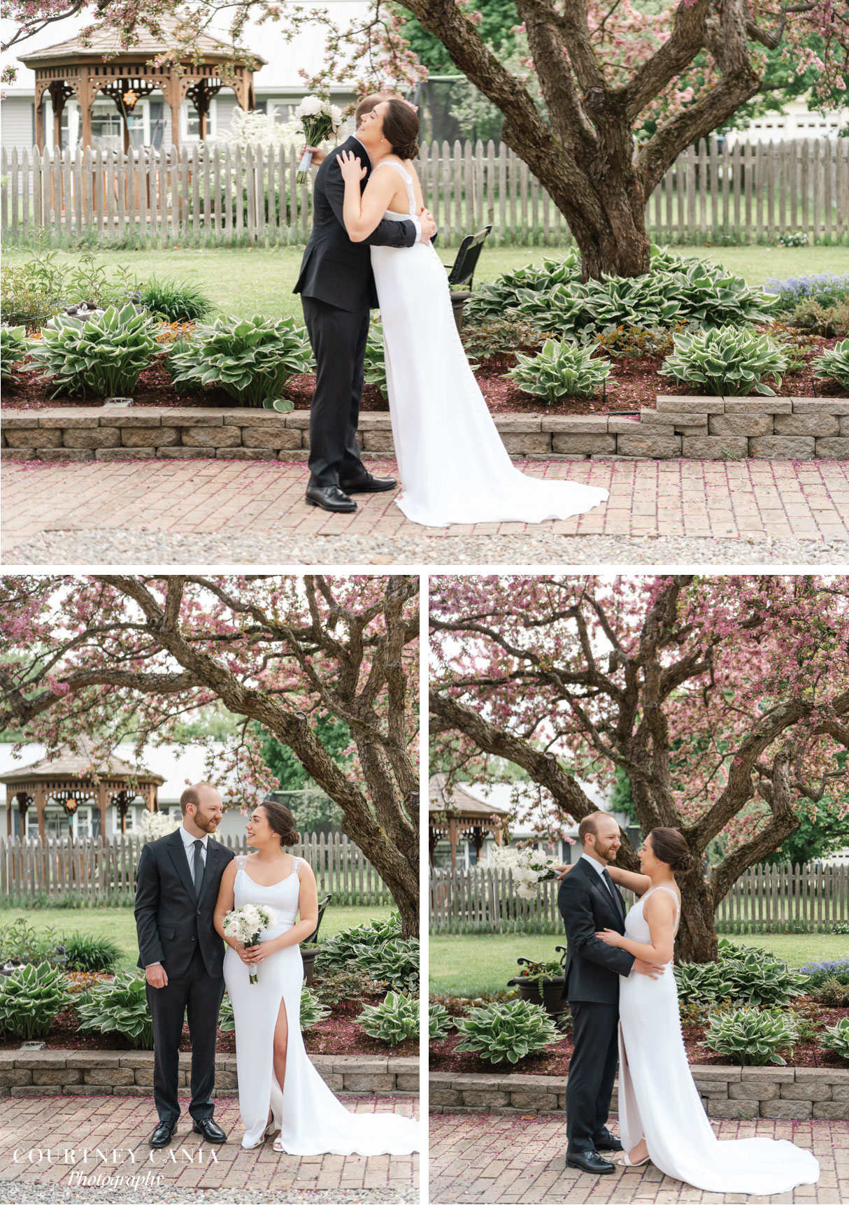 couple share first look under a blooming cherry tree in front yard of vermont residence