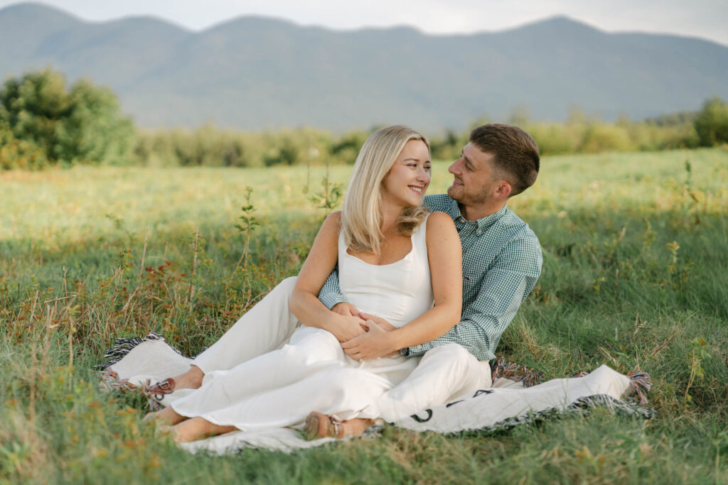 close up of couple sitting on blanket sugar hill white mountain engagement session