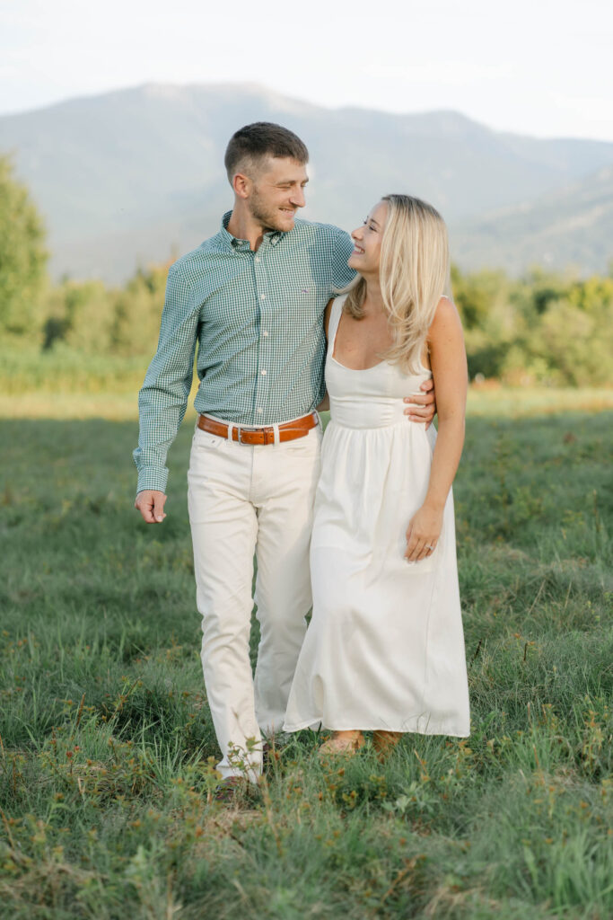 couple walking toward camera arm in arm sugar hill white mountain engagement session