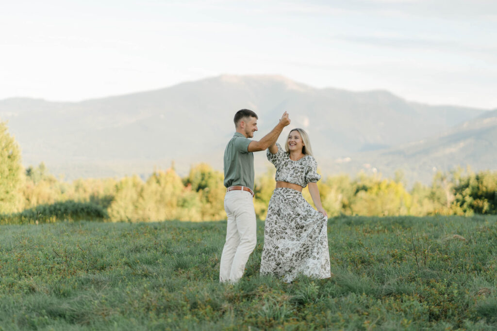 couple twirling during sugar hill white mountain engagement session