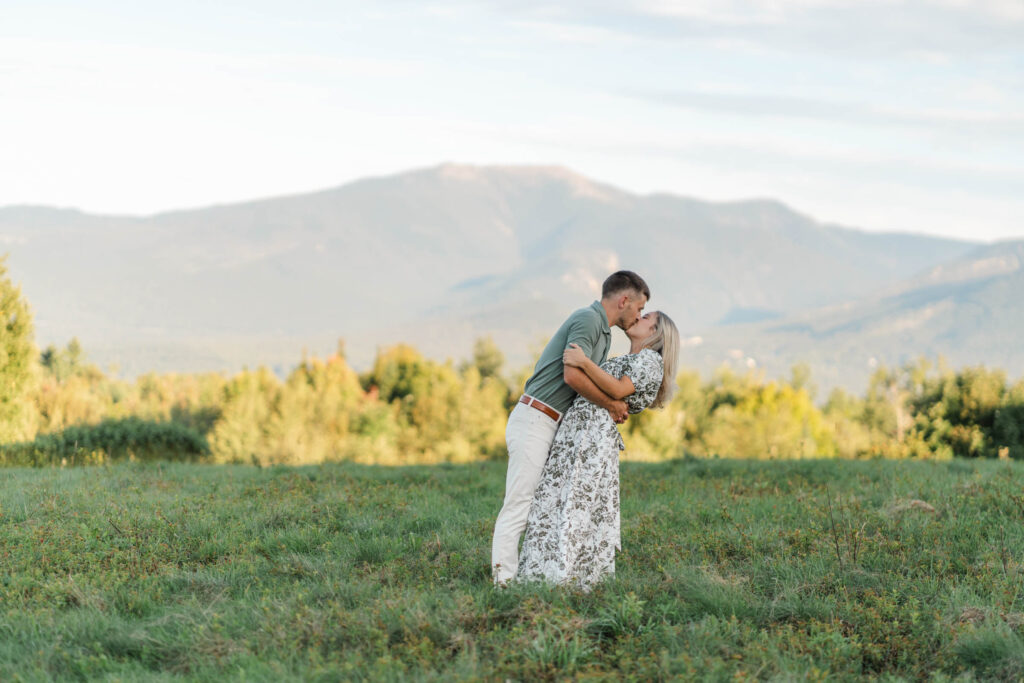 couple dip and kiss during sugar hill white mountain engagement session