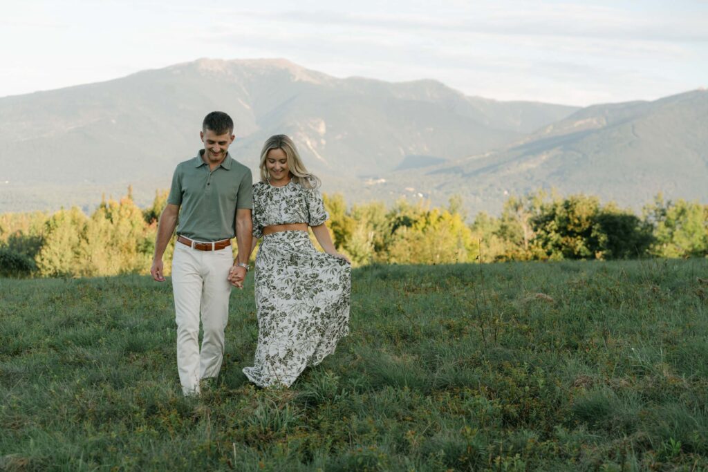 couple walking toward camera during sugar hill white mountain engagement session