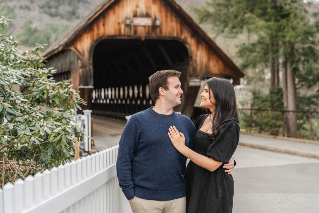 standing in front of woodstock covered bridge during woodstock vermont engagement session