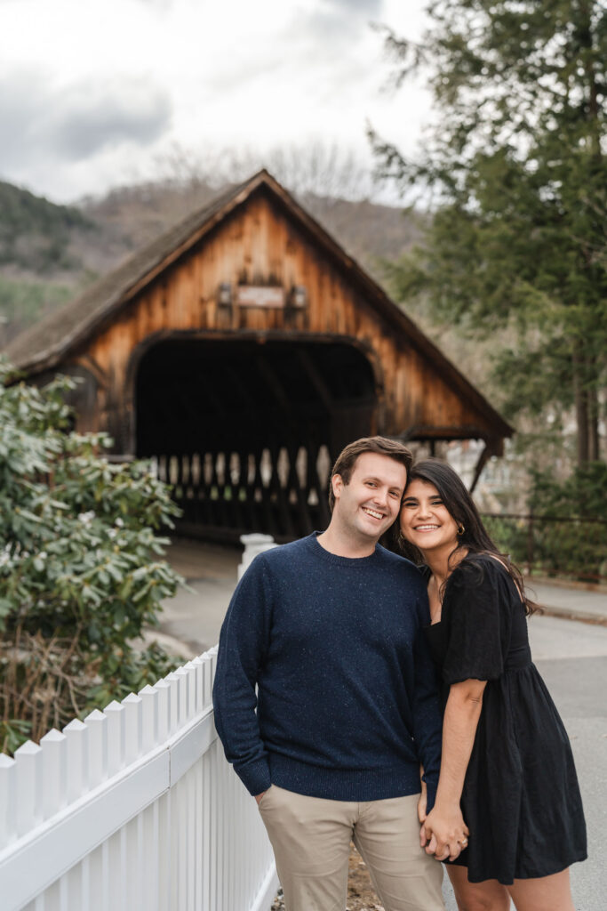 smiling and holding hands during woodstock vermont engagement session