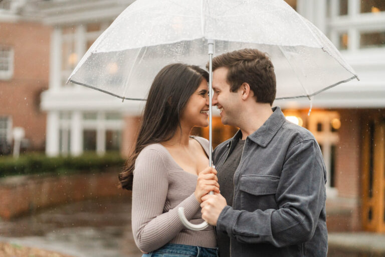 Couple kissing under an umbrella during woodstock vermont engagement session