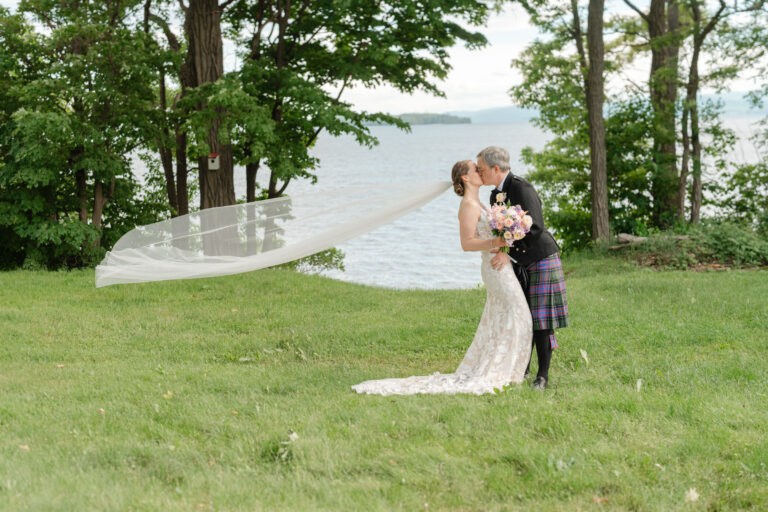 Bride and Groom Kiss after Just Married, Veil Flying in the wind, Vermont Wedding at Snow Farm Vineyard in South Hero, Vermont