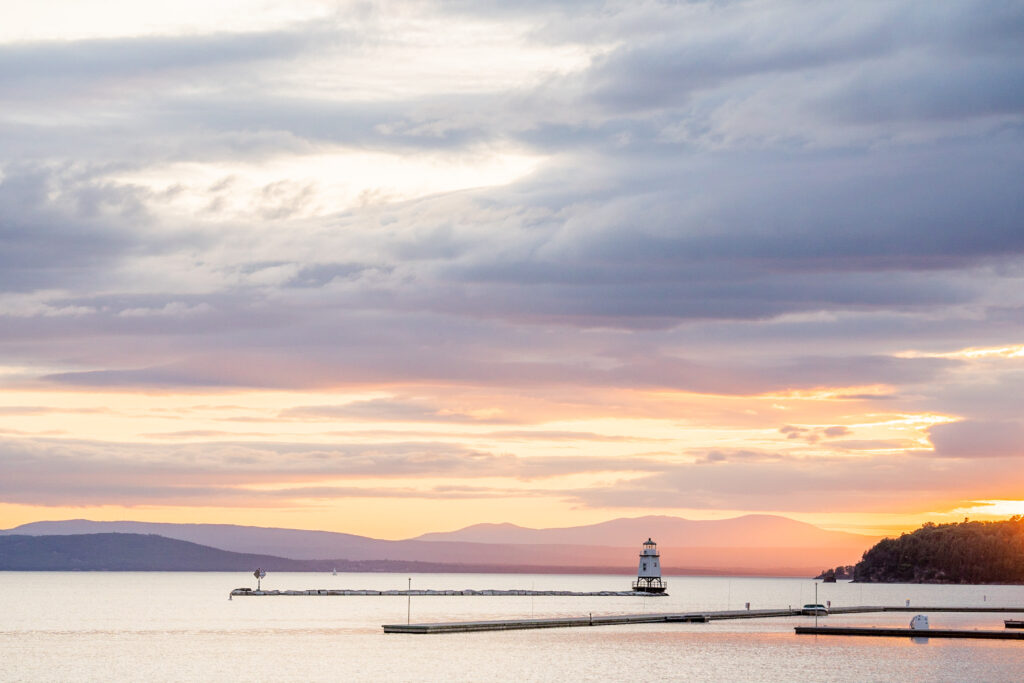 cotton candy sunset sky over lake champlain at burlington waterfront. perfect spot for your vermont wedding
