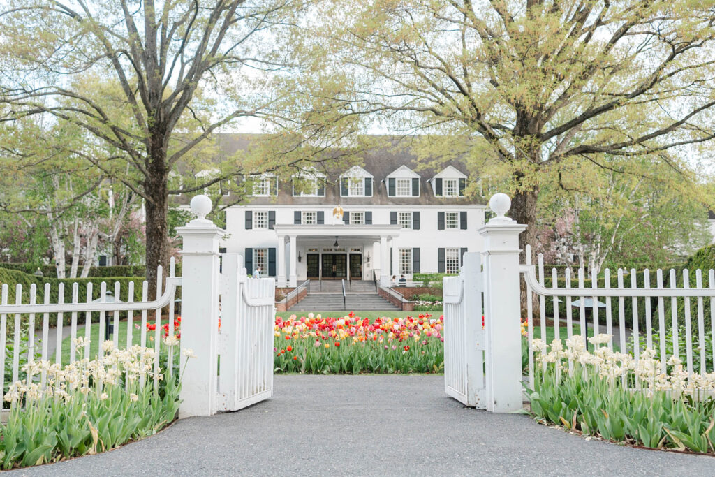 Beautiful Woodstock Inn on a spring day with tulips in the front area. Vermont Wedding venue
