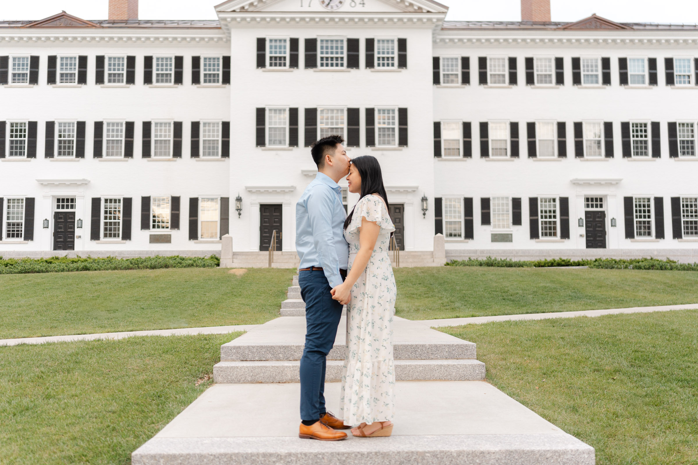 engagement couple kissing foreheads during engagement session in front of dartmouth hall in hanover nh