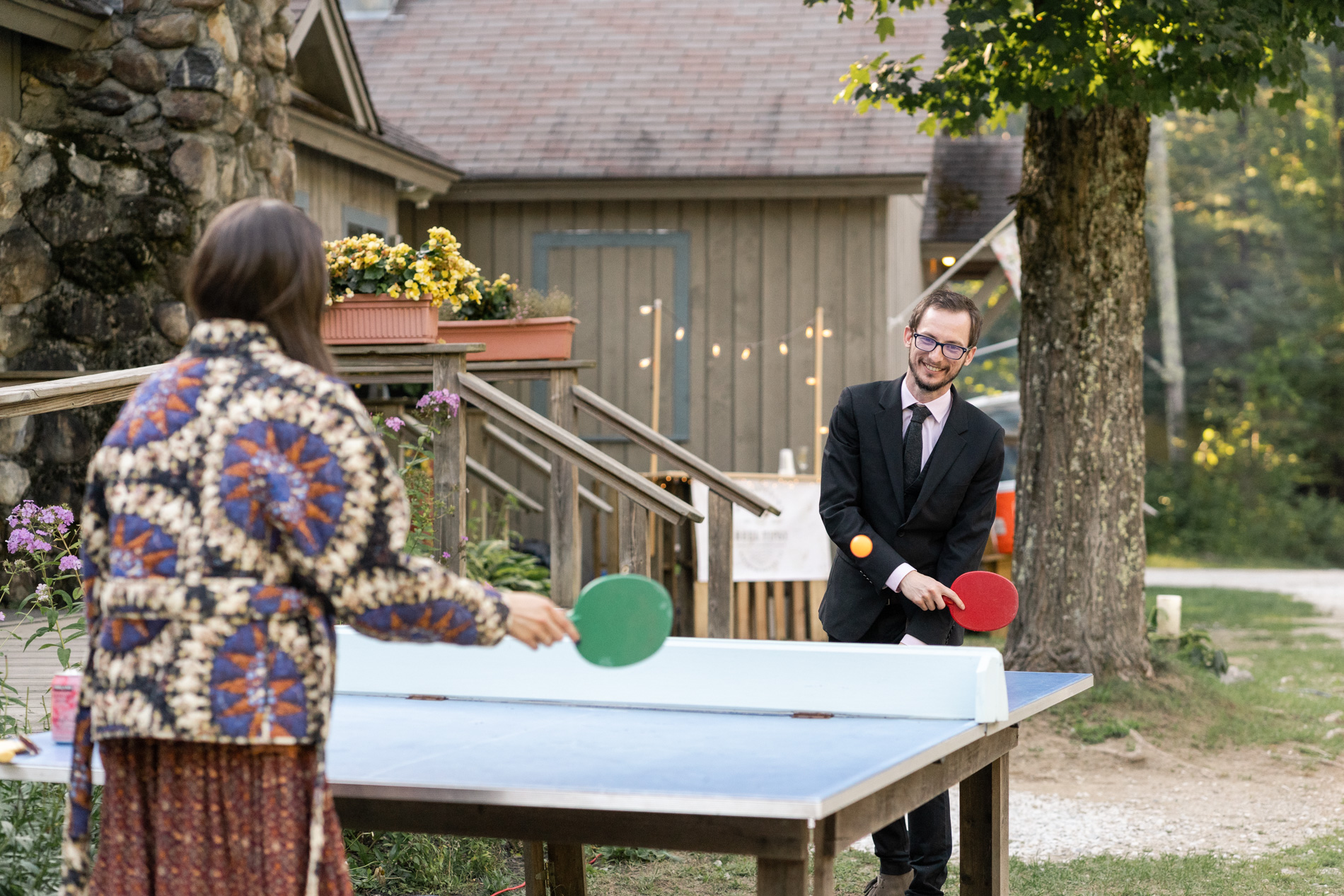 Playing Ping Pong at a camp wedding