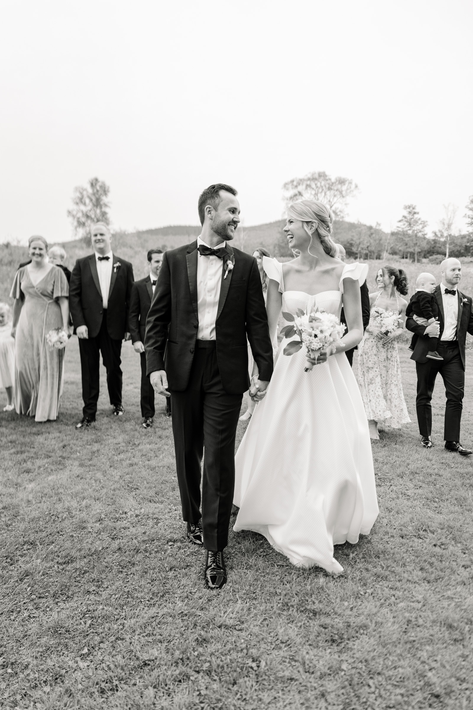 vermont wedding at Inn at round barn bride and groom walking ahead of wedding ceremony