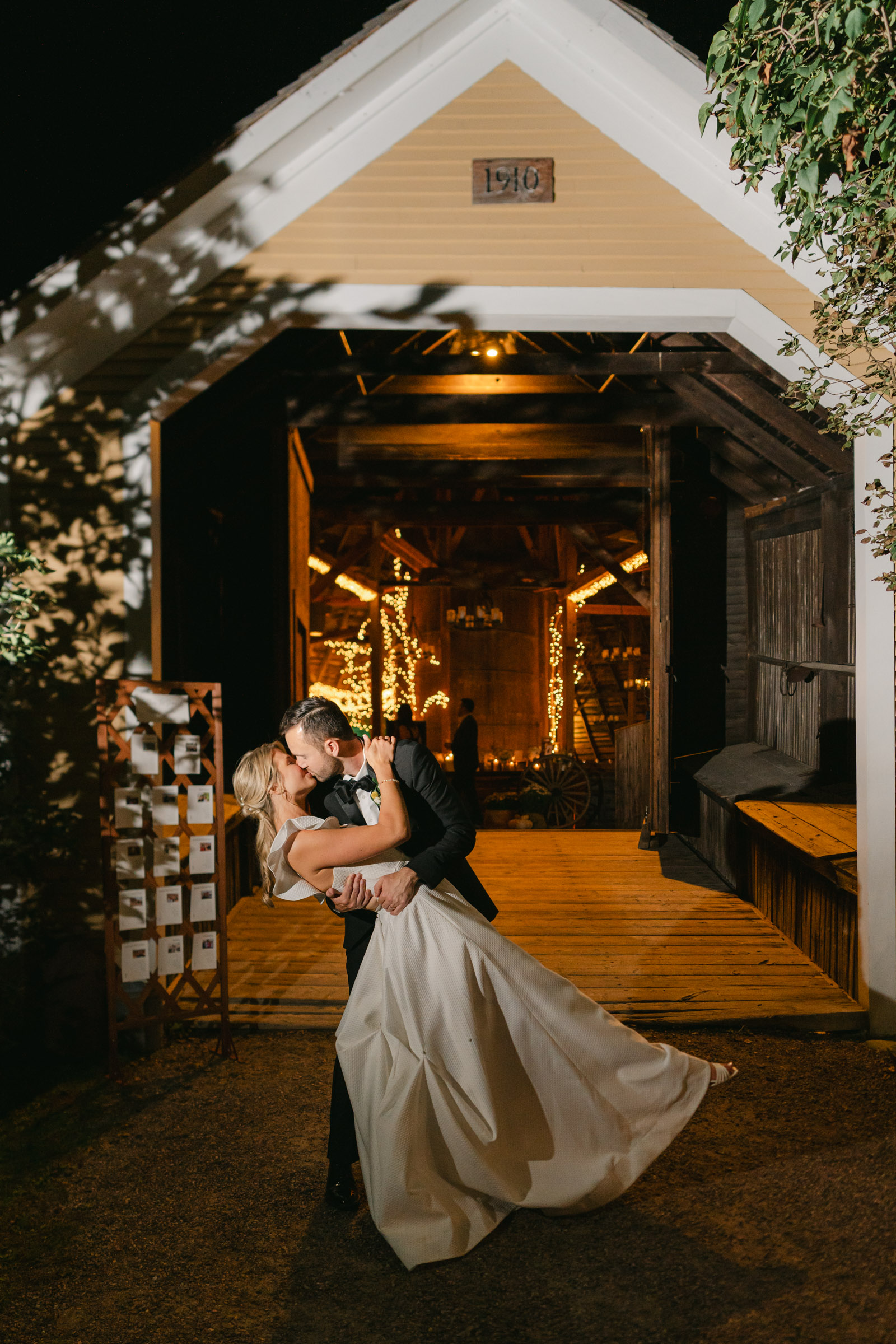 vermont wedding at Inn at round barn kiss and dip in front of the barn