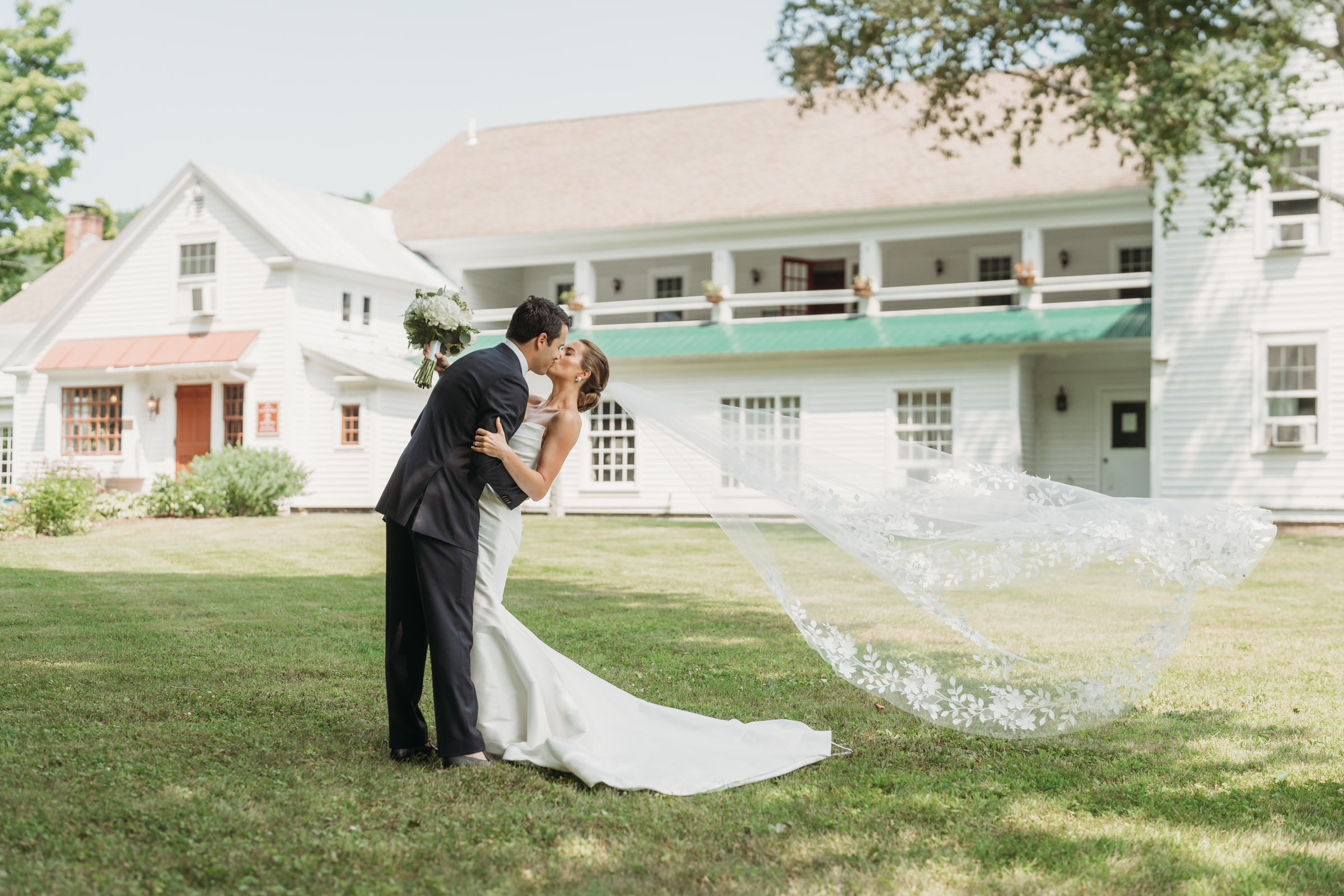Quechee Inn Vermont Wedding, photo of bride and groom with veil flying over grass