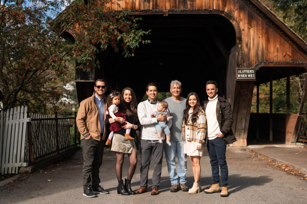 group portrait in front of Woodstock Covered bridge during the fall