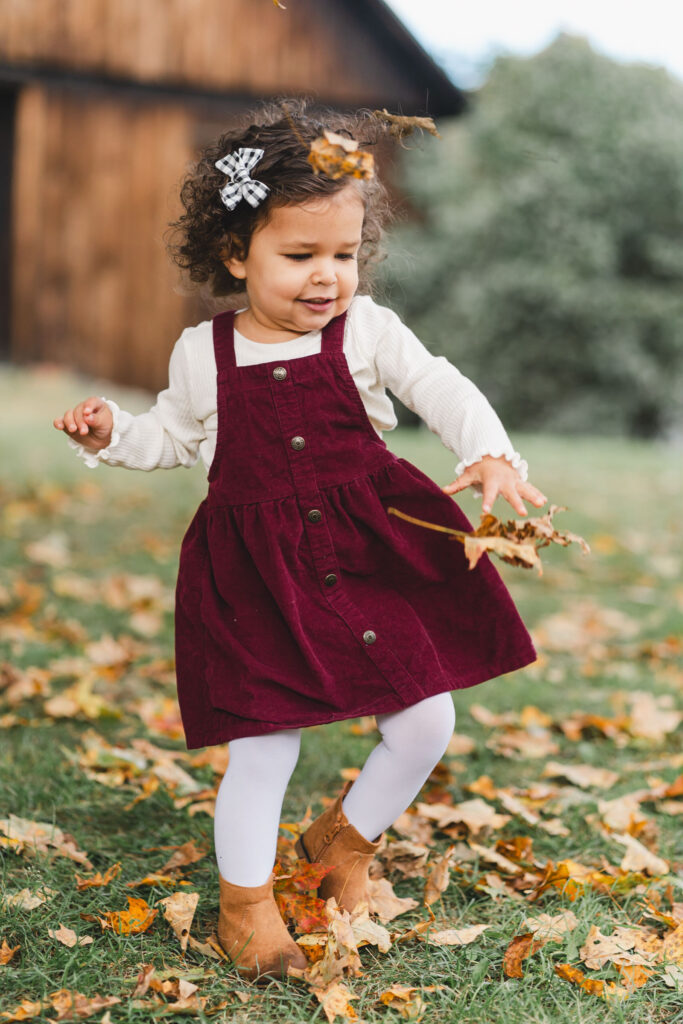 October Family Photos in Woodstock Vermont, close-up of young girl in maroon jumper