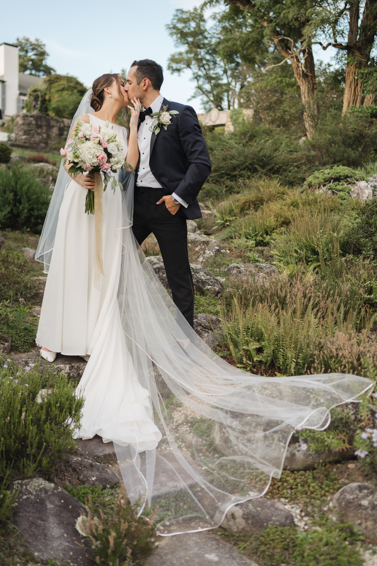 Couple kissing in garden of The Fells, Sunapee, NH