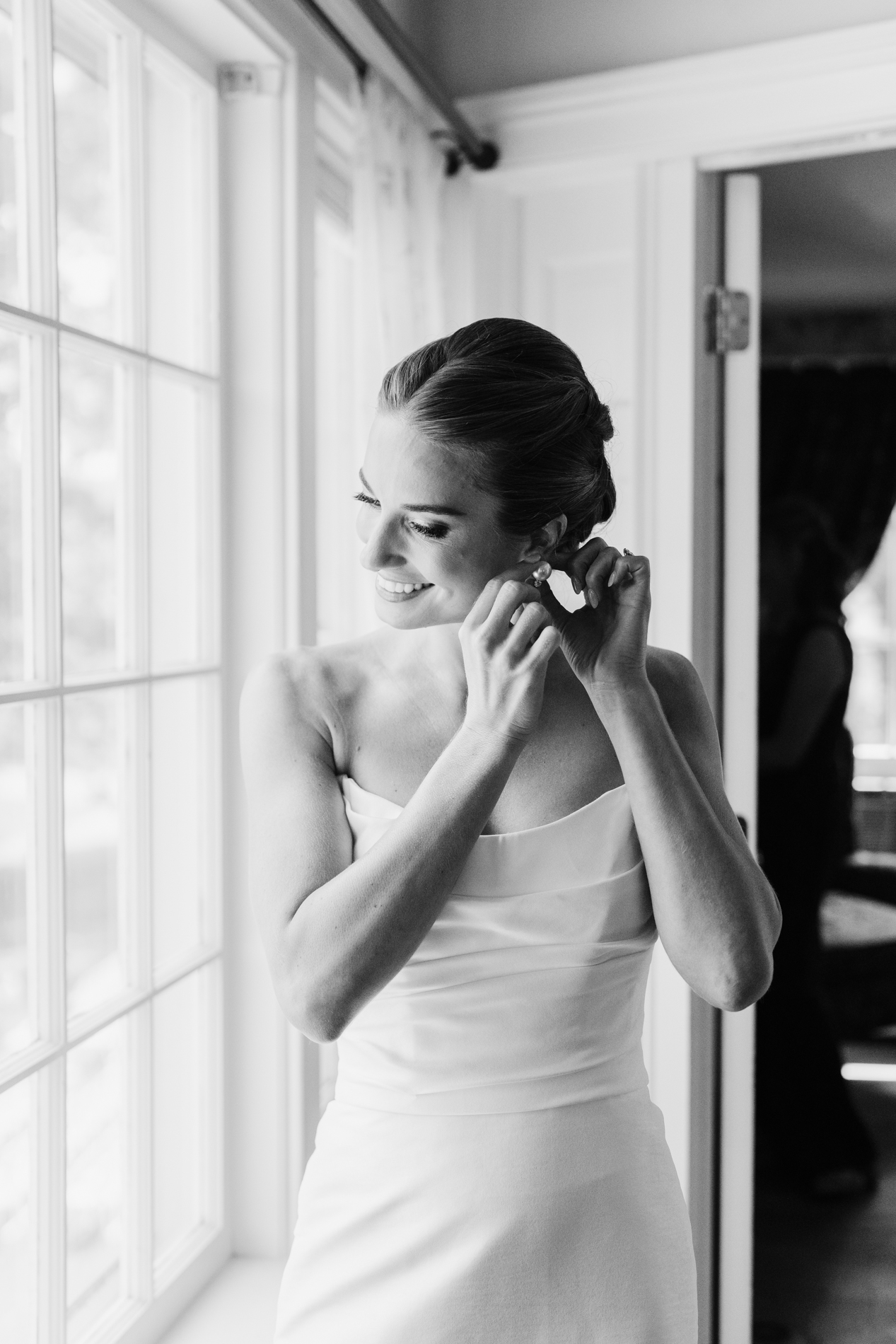 new england wedding photographer - photographing Vermont wedding at Quechee Inn - bride putting on earrings