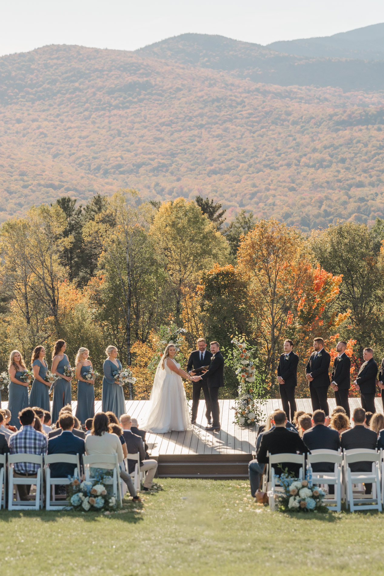 Wedding party and bride and groom on platform at concert meadow at Trapp Family Lodge