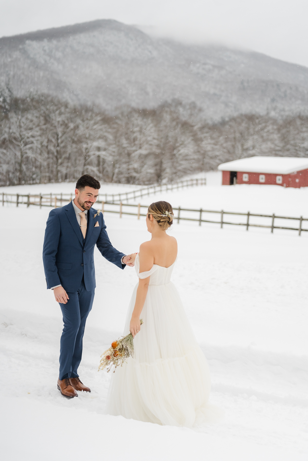 couple sharing a first look in the snow at OQ Farm