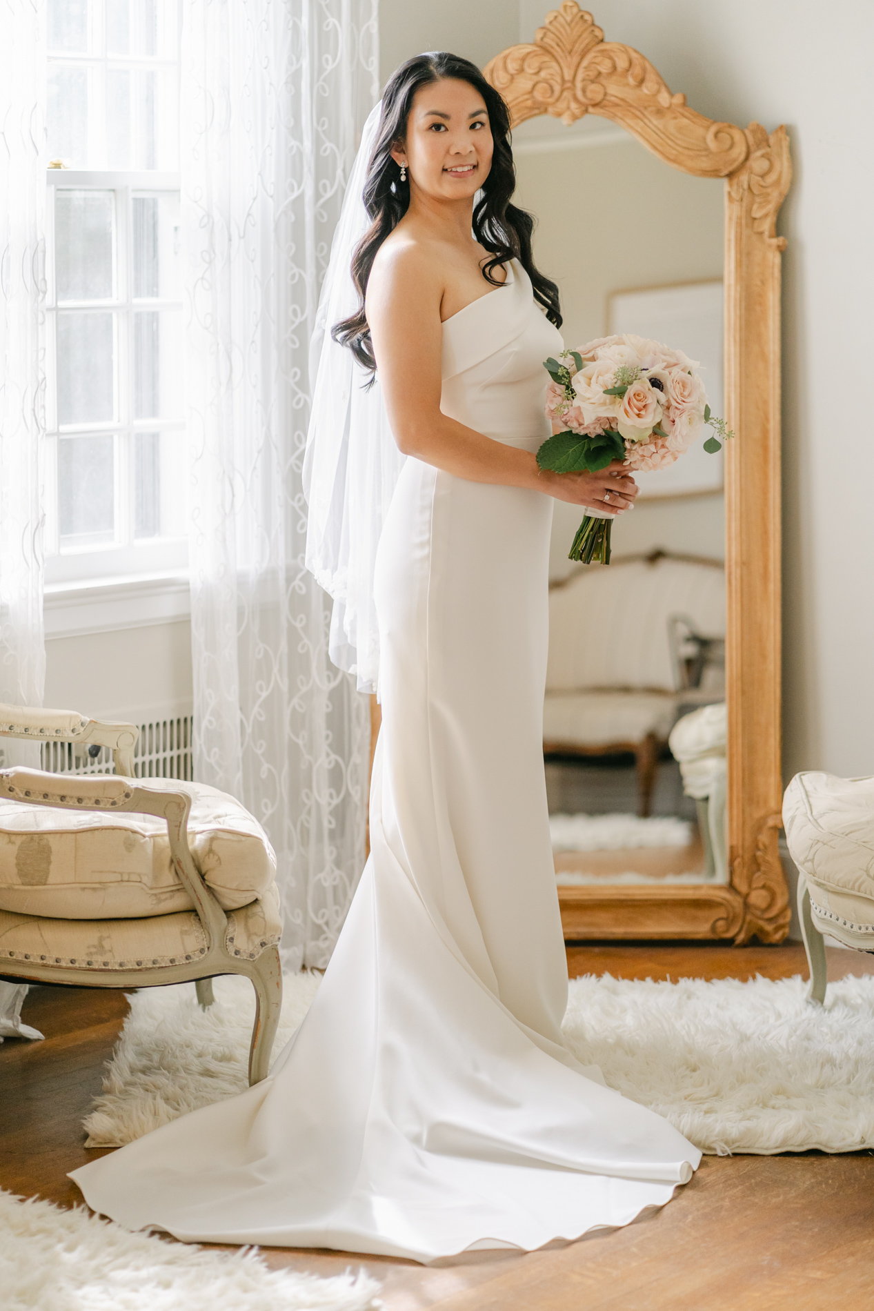 Bride standing in mirror at Connemara House, North Shore Wedding