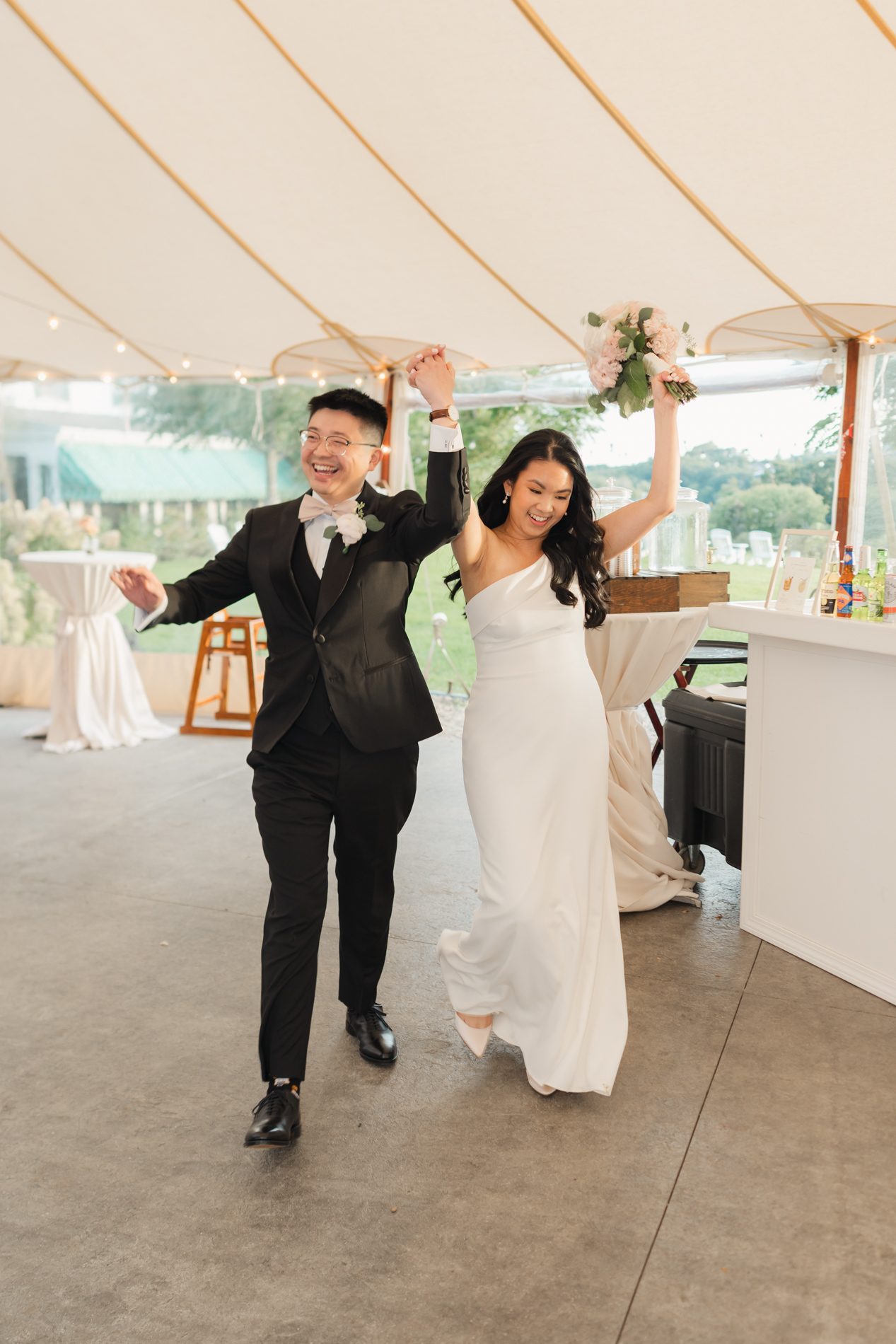 Just married couple entering tent, north shore boston wedding at Connemara House
