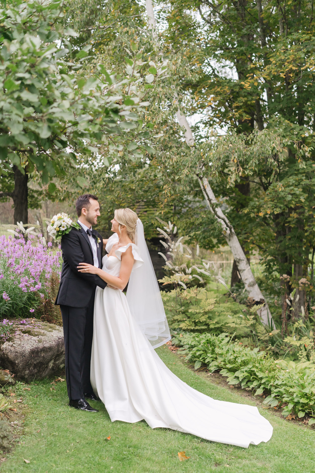 New England Wedding Photographer - Courtney Cania captures Inn at round barn farm wedding - couple embrace in garden