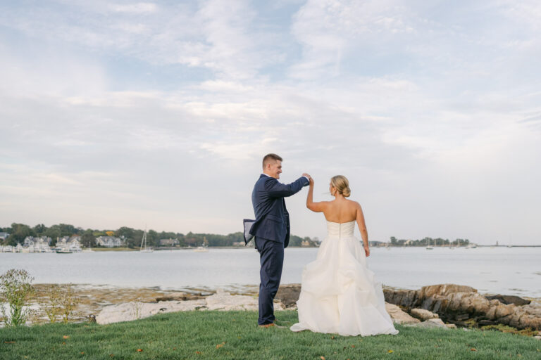 Couple twirling by the sea at Wentworth by the sea country club wedding