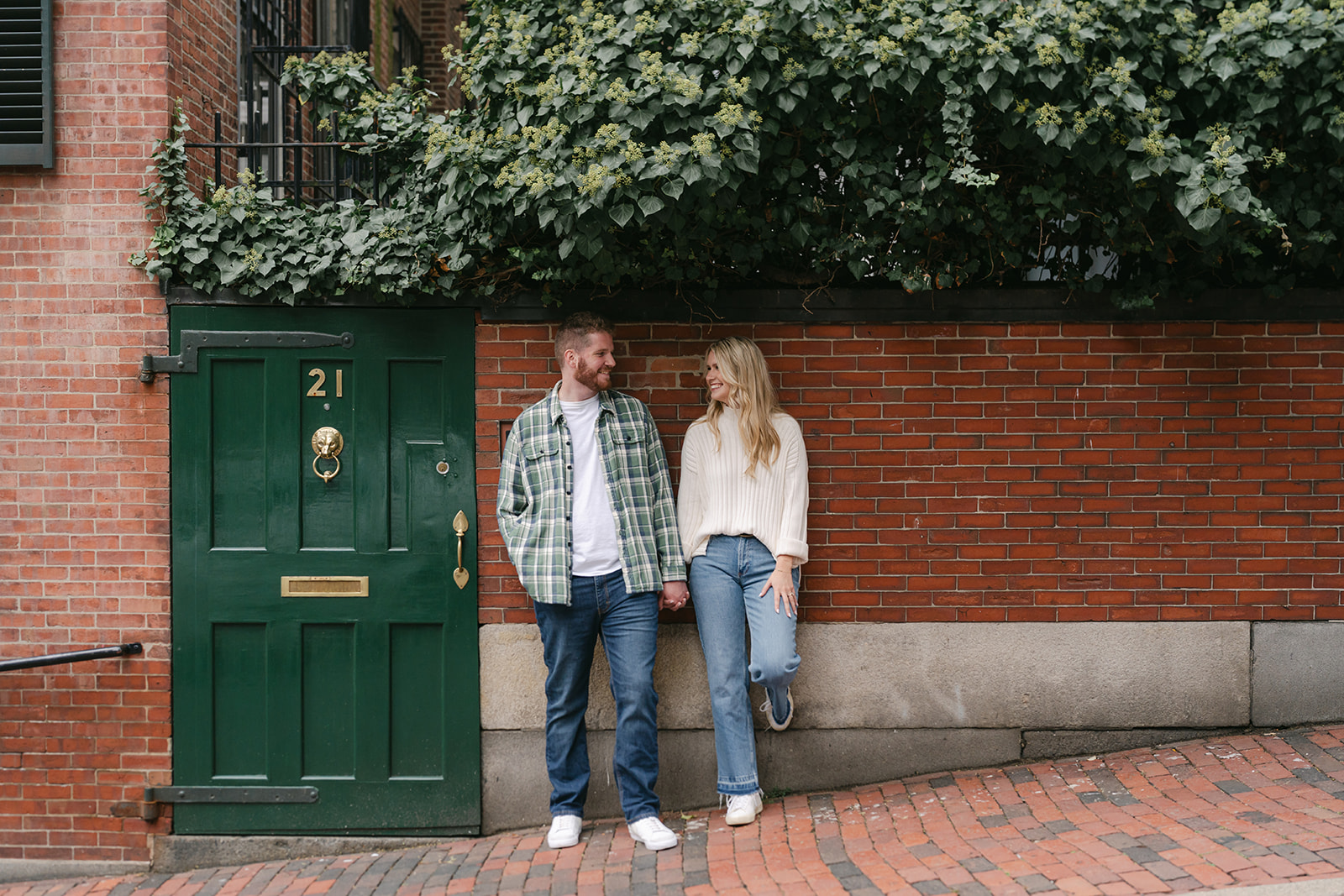 Couple stand near brick wall during Boston Engagement Session