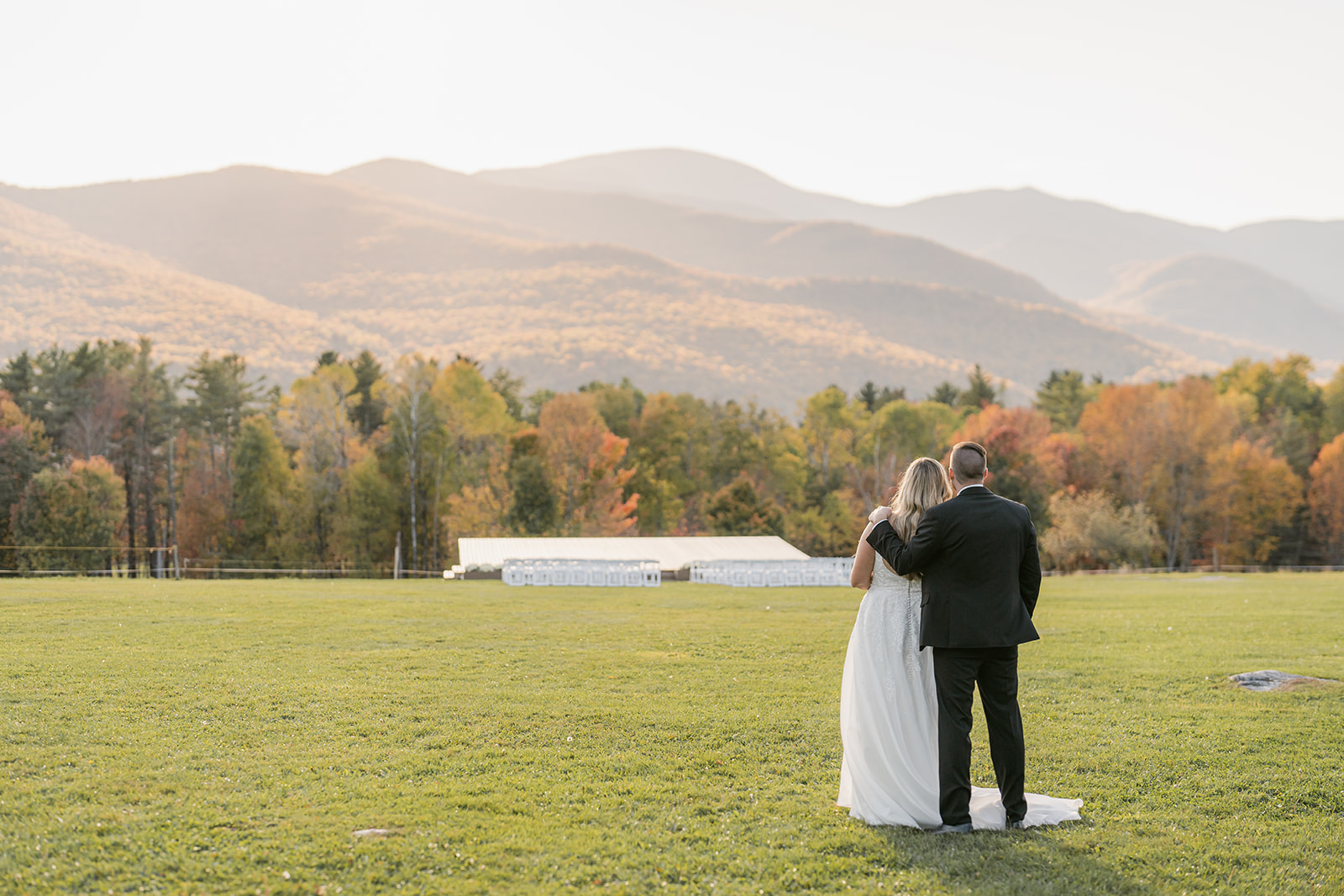 Bride and groom look out at views from concert meadow - Fall Trapp Lodge wedding
