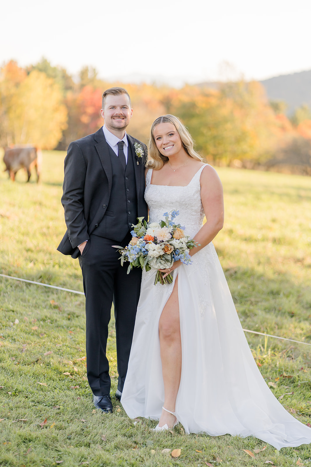 Couple posing near cattle at Von Trapp Lodge wedding venue