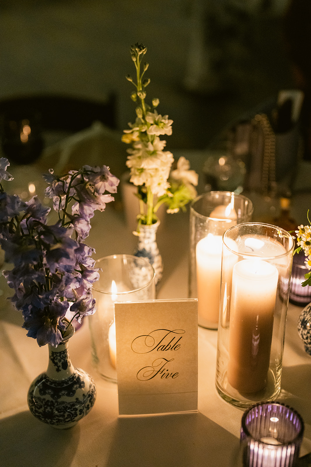 glowing candles and flowers on table