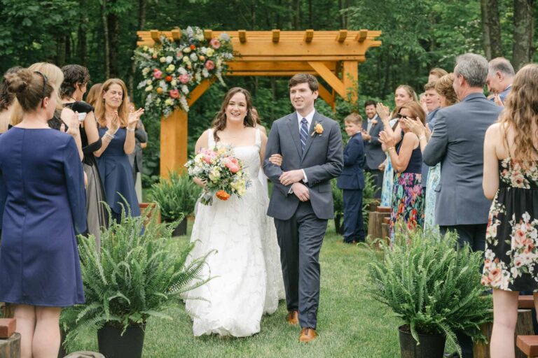 Couple processing down aisle at Mad River Barn spring wedding