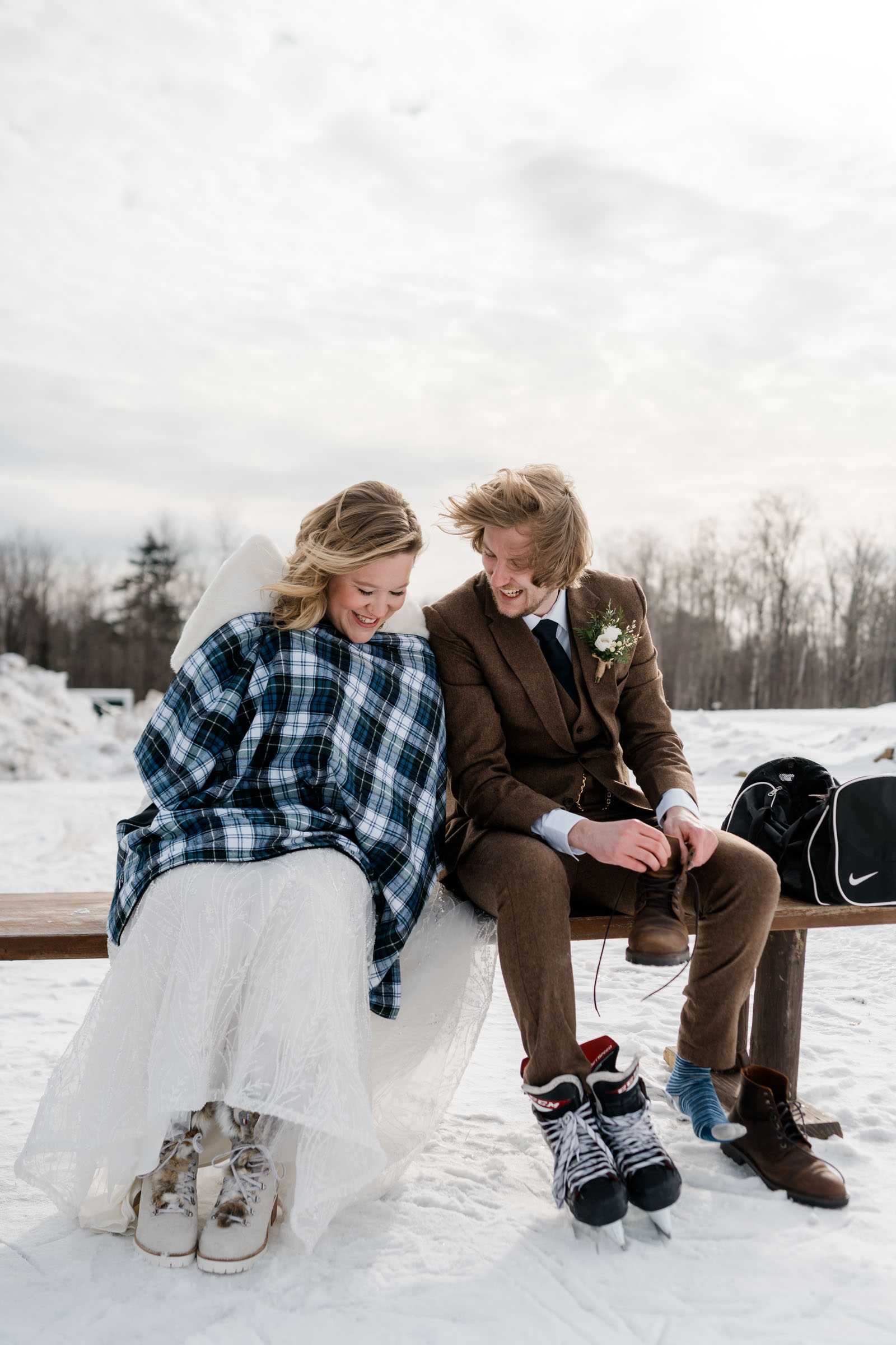 couple seated on bench after their ice skating first look
