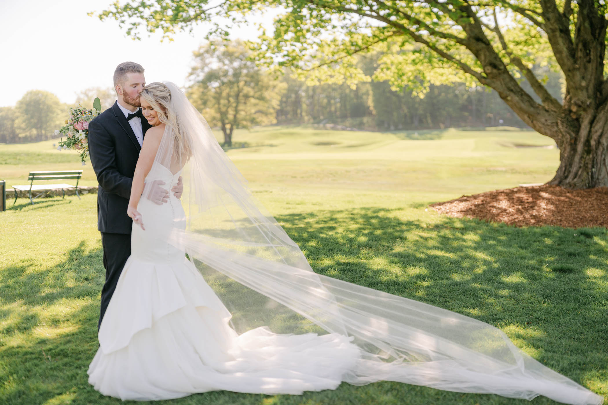 Couple posing on a golf course at oak hill country club wedding
