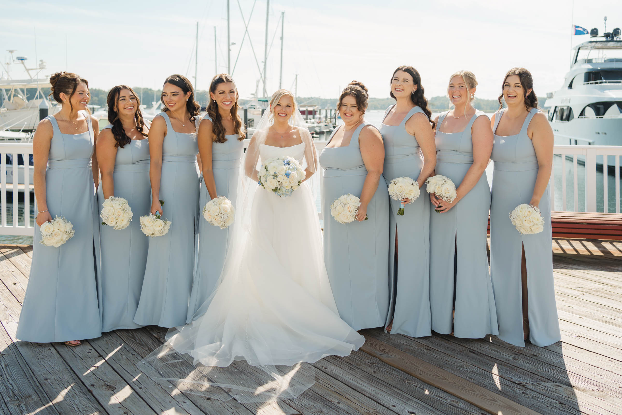 Bride standing with bridesmaids on dock - Wentworth by sea country club wedding
