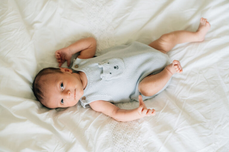 Baby lying on sheet during in-home newborn session