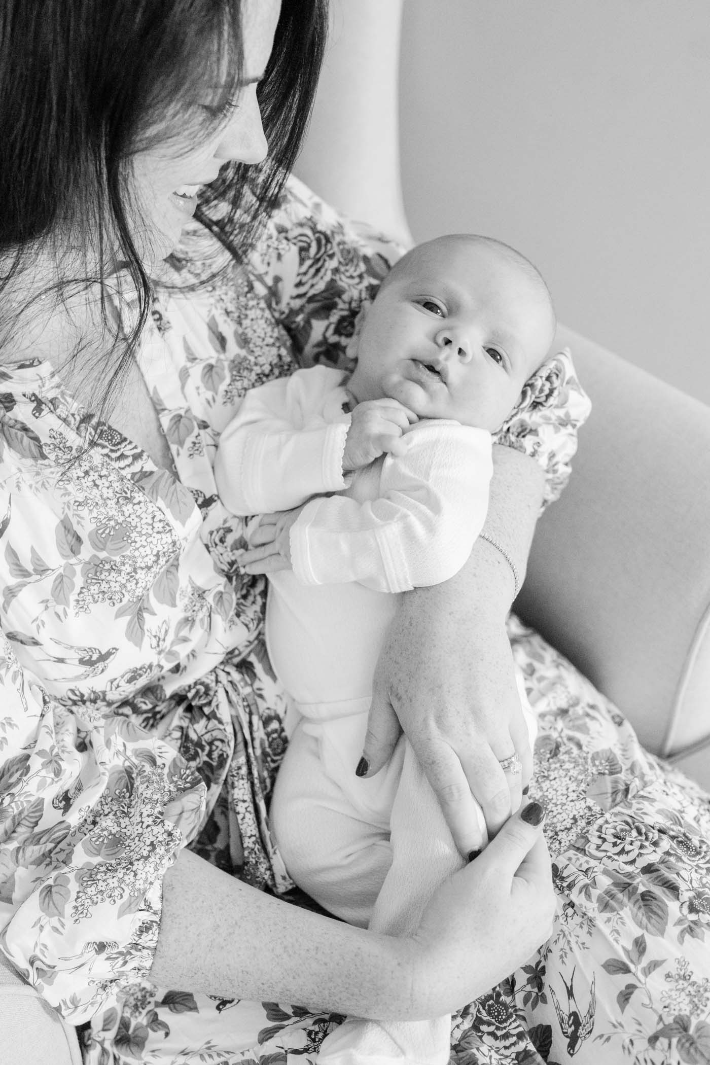 Mother holding her newborn baby during upper valley newborn in-home photo session