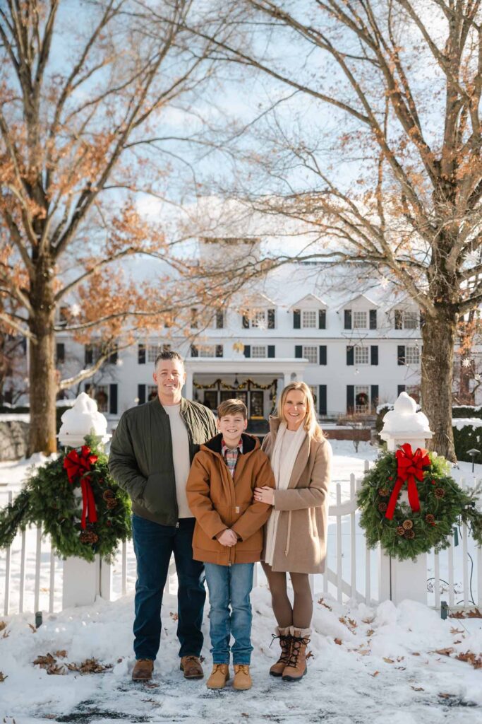 Family posing in front of Woodstock Inn during winter family photo session