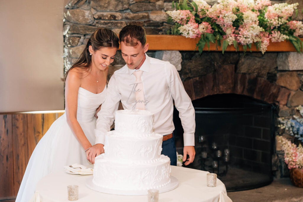 Harrington Farm Wedding - bride and groom cutting the cake