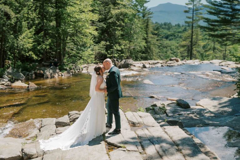 Bride and Groom, married Couple kiss at Jackson Falls during white mountain wedding at Eagle Mountain House