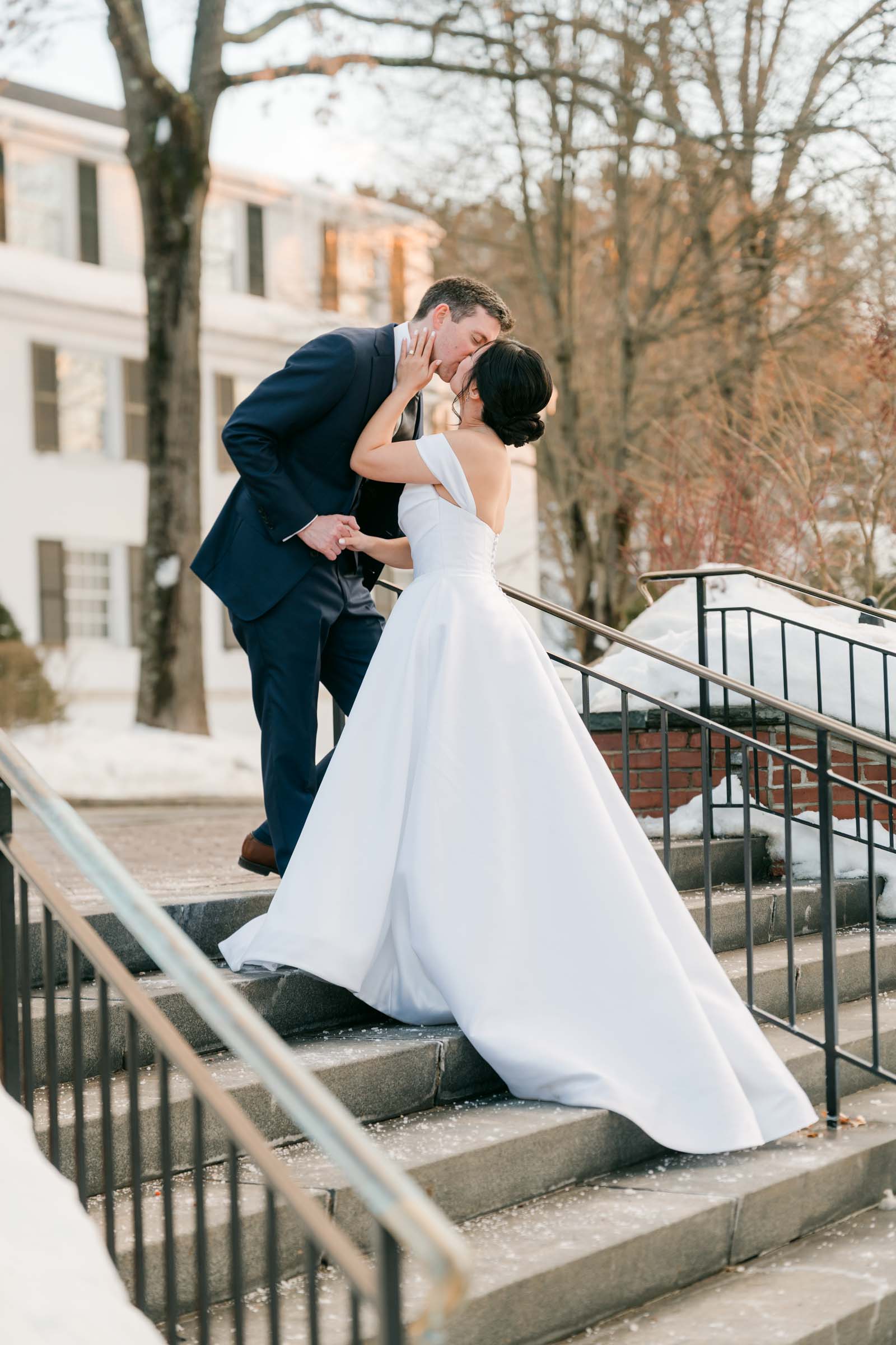 Woodstock Inn Winter Wedding - couple kissing on staircase